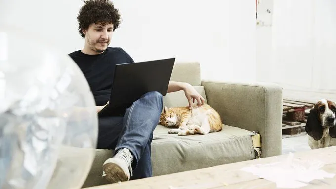 man with cat on couch