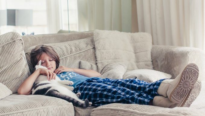 kid with cat on couch