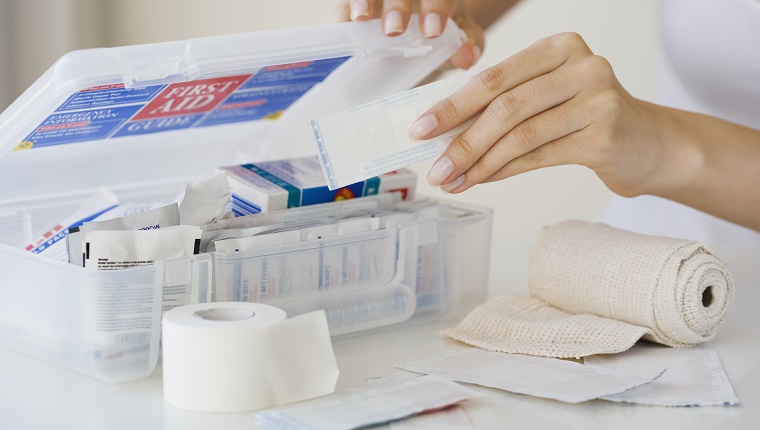 Woman packing first aid kit