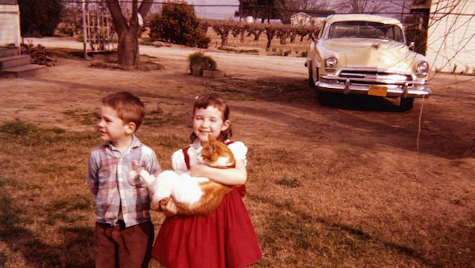old photo of kids on lawn with cat