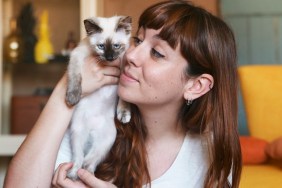 Young woman with kitten at home