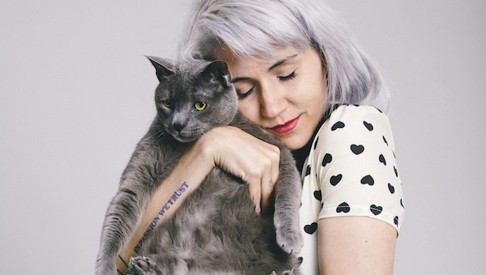 woman hugging kitty on hug your cat day
