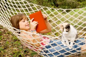 Seven years old reading in a hammock with her cat on her lap.More atBest friends Lightbox:
