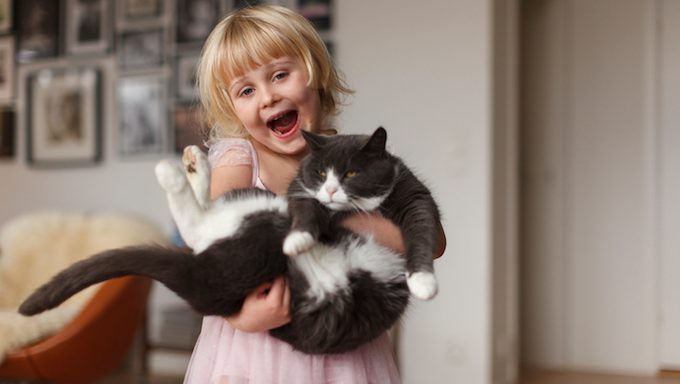 girl holding cat