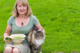 A contented gardener with her freshly grown peas and her contented cat.