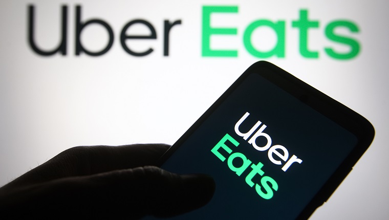 UKRAINE - 2021/06/04: In this photo illustration, Uber Eats logo of a US online food ordering and delivery platform is seen on a smartphone in a hand. 