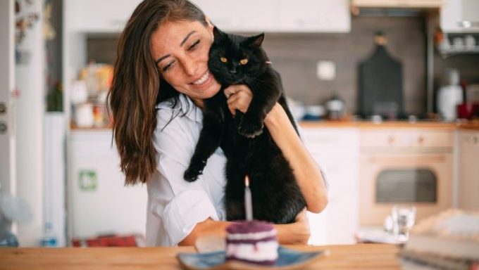 woman celebrating cats birthday codependent with cat