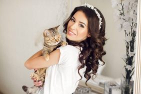 smiling bride with cat at wedding